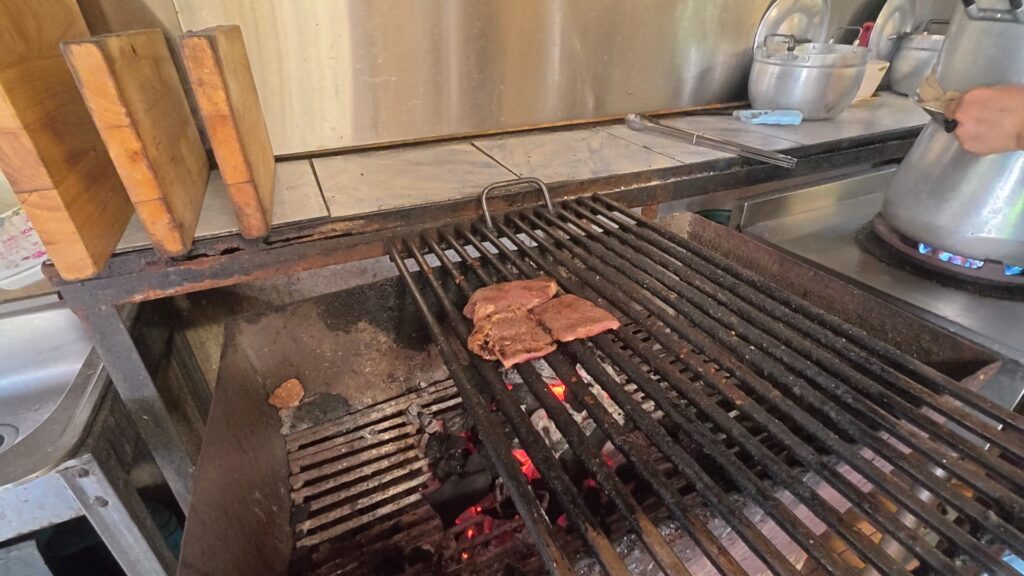 炭火グリルで焼かれる牛肉のスライス